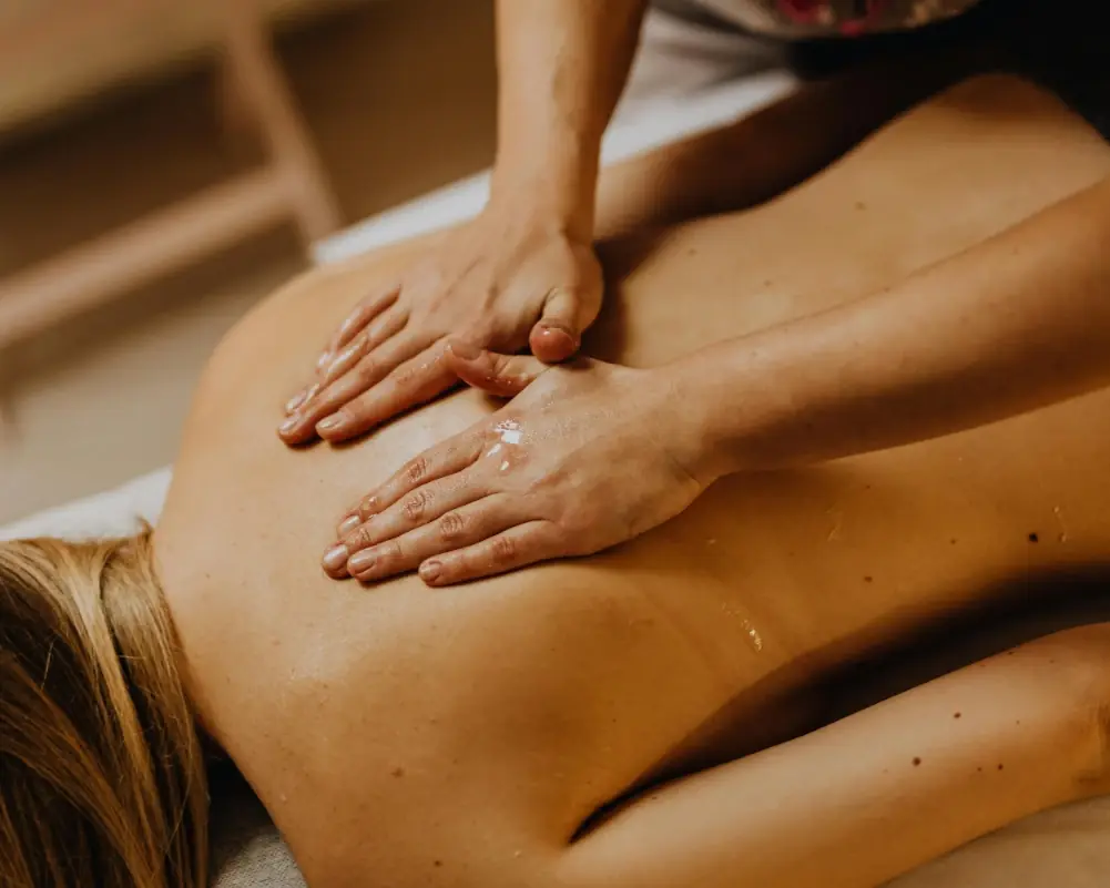 Warm massage oil and folded towels prepared for a deep tissue massage session