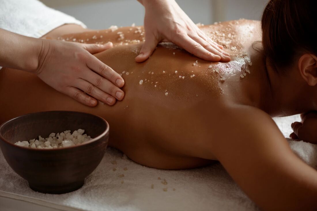 Professional in-room massage setting with a calm, elegant wellness atmosphere